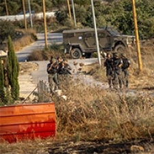 Military personnell stand in groups.