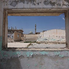 View of buildings through empty window. 