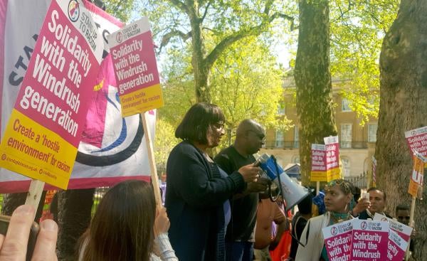 Members of the Windrush generation and their families are joined by then-shadow home secretary Diane Abbott (center) at a rally outside Downing Street in London, May 5, 2018.