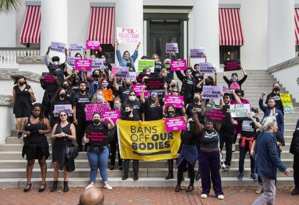 Advocates stand at the Florida Capitol in Tallahassee to protest a bill before the Florida legislature to limit abortions, February 16, 2022.