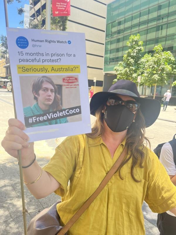  A protester in Perth, Australia, carries a sign with a Human Rights Watch tweet on it using our Daily Brief headline, "Seriously, Australia?", about the 15-month sentence of Violet Coco for peaceful protest. December 5, 2022. (c) Sophie McNeill, Human Rights Watch 2022