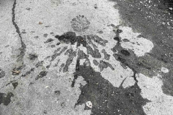 The fragmentation pattern left by an apparent cluster munition impact during an attack on a populated neighborhood in Kherson city 