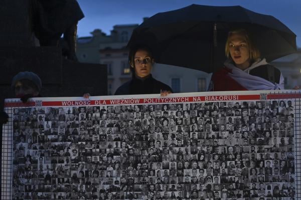 Members of the Belarusian diaspora outside the Adam Mickiewicz monument in Krakow, Poland.