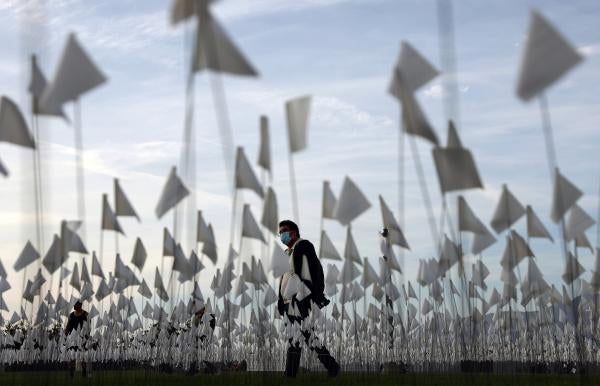A white flag memorial installation outside Griffith Observatory honoring the nearly 27,000 Los Angeles County residents who had died from COVID-19 .