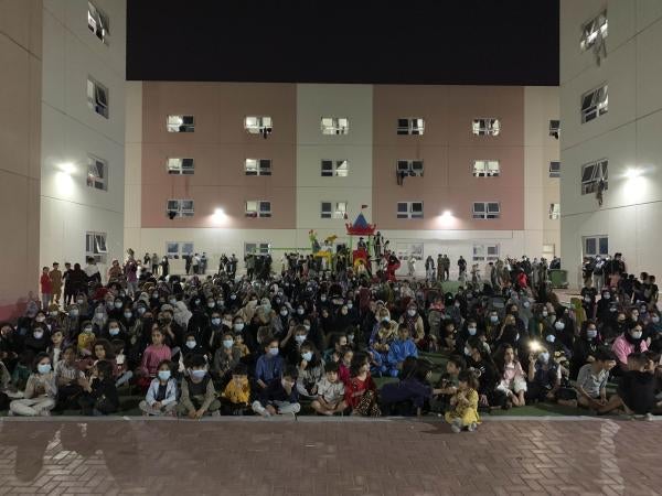 Afghans rally in an Afghan refugee camp in Abu Dhabi, the capital of the United Arab Emirates, to protest their non-transfer to the United States, February 13, 2022.