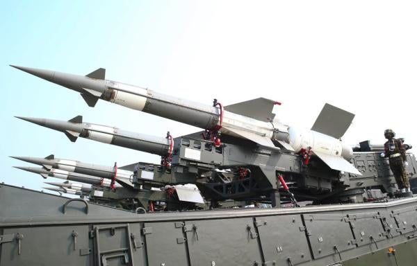 Members of the Myanmar military stand atop trucks loaded with missiles during a parade to commemorate Myanmar's 77th Armed Forces Day.