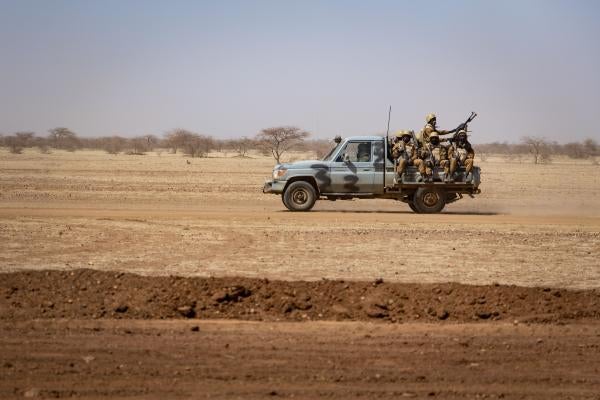 Burkina Faso soldiers patrol aboard a pickup truck on the road from Dori to the Goudebo refugee camp, on February 3, 2020. 
