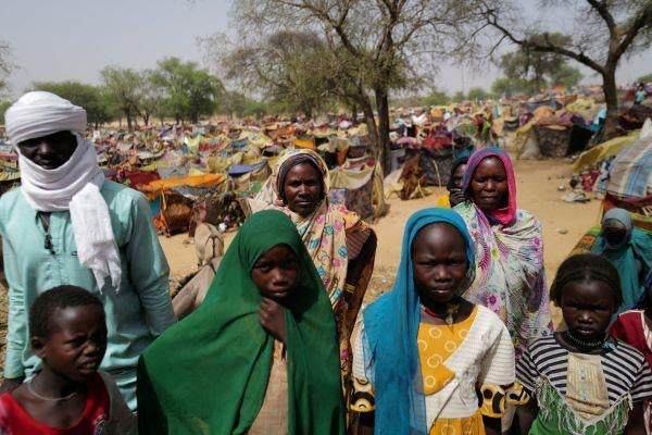 udanese people who fled the conflict in Sudan's Darfur region and were previously internally displaced in Sudan, look on as they stand near makeshift shelters at the border between Sudan and Chad, while taking refuge in Borota, Chad, May 13, 2023