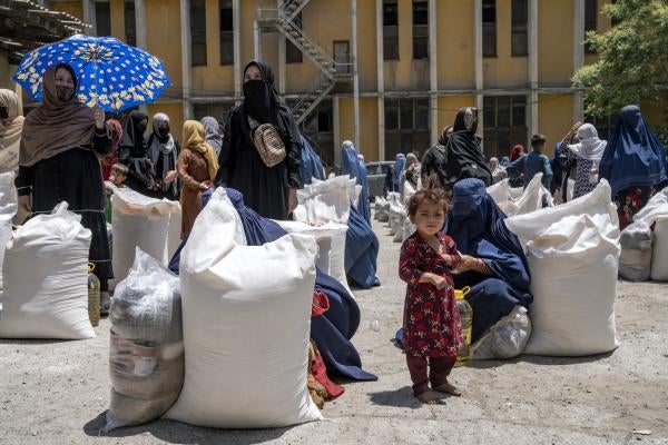 Afghan women receive food rations distributed by a humanitarian aid group, in Kabul, Afghanistan, May 28, 2023.