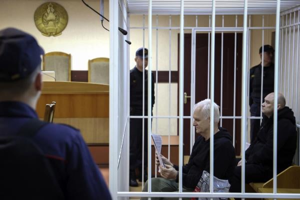 Ales Bialiatski, the head of Belarusian Viasna rights group, centre, sits in a defendants' cage during a court session in Minsk, Belarus, January 5, 2023.