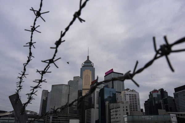 Hong Kong's cityscape through barbed wire.