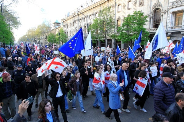 Protesters march outside the parliament building in protest of “the Russian law” in Tbilisi, Georgia, April 9, 2024. 