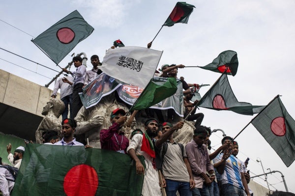 A group of people waving flags at a protest