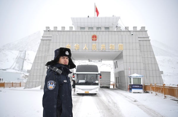 A Chinese police officer on a snowy road.