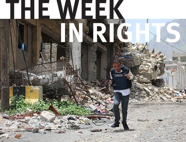 Figure walks through rubble in Yemen.