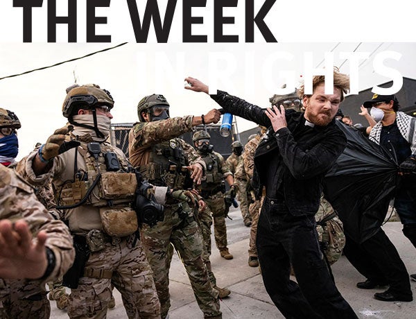 Protesters confront military personnel. 