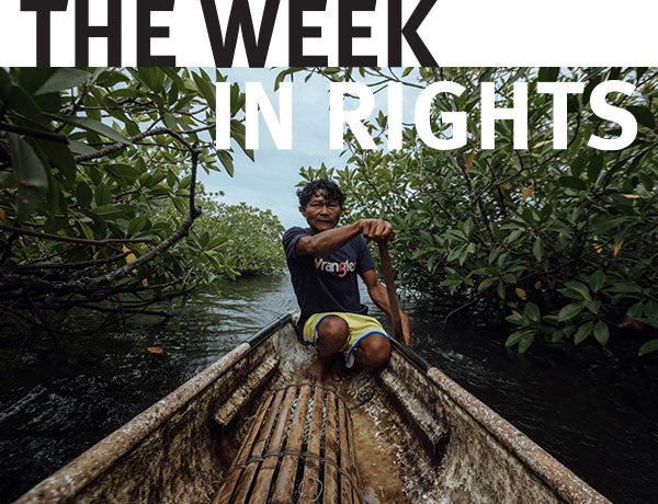 One figure navigates boat through river. 