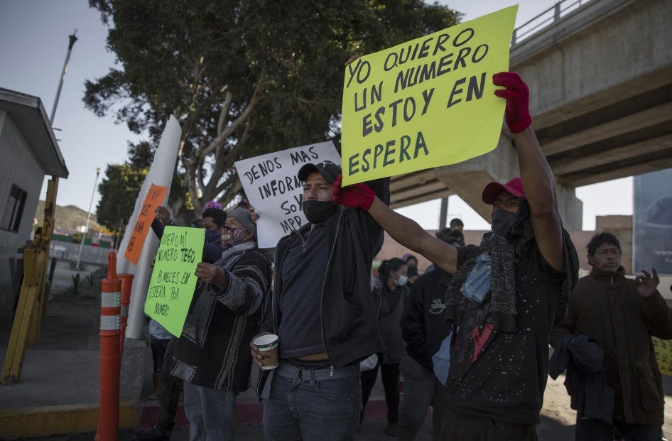 Migrants demonstrate at the border between Tijuana and San Diego calling on US authorities to open the border and restart the process of accepting asylum applications, February 18, 2021.