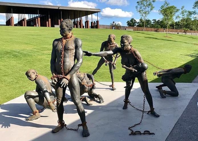 A sculpture of African slaves by Ghanaian artist, Kwame Akoto-Bamfo, at the beginning of the National Memorial for Peace and Justice in Montgomery, Alabama. 