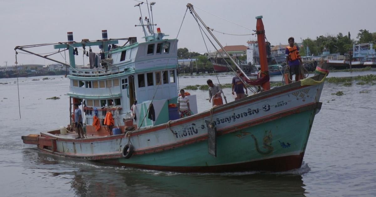 Bang Saen, Thailand: Thai fisherman hauling fishing nets into his