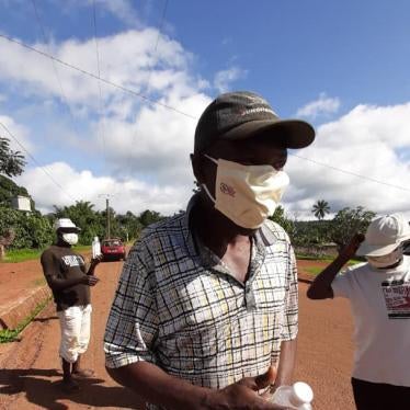 A man who received a protective mask and a bottle of hand sanitizer donated by “Survival Initiative”, a fundraising initiative launched by opposition leader Maurice Kamto, Bangoura,Cameroon, May 2020.