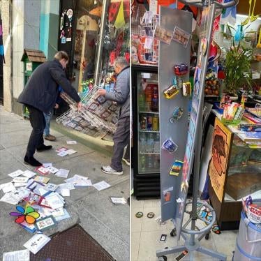 In this screenshot, a man helps a shop owner pick up a display stand after a group of teenagers vandalize the store in Chinatown San Francisco on March 16, 2020. 