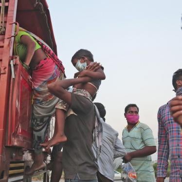Migrant workers board a truck to return to their villages during a nationwide lockdown, Hyderabad, India, May 12, 2020.