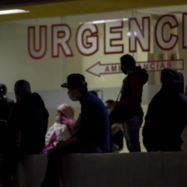 People were protective masks waiting outside an emergency room.