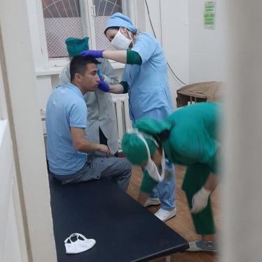 Abdulloh Ghurbati receives medical help after an attack on May 11, 2020, Dushanbe, Tajikistan.