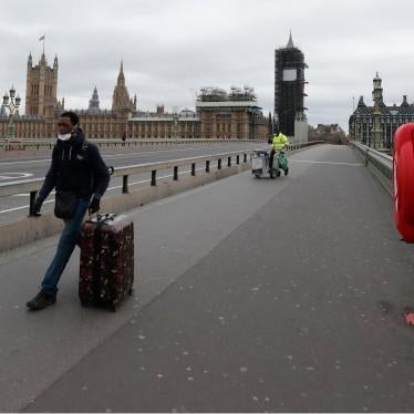A man wheels his suitcase across Westminster Bridge looking towards the Houses of Parliament, at would normally be rush hour as the lockdown to prevent the spread of the coronavirus continues in London, March 30, 2020.