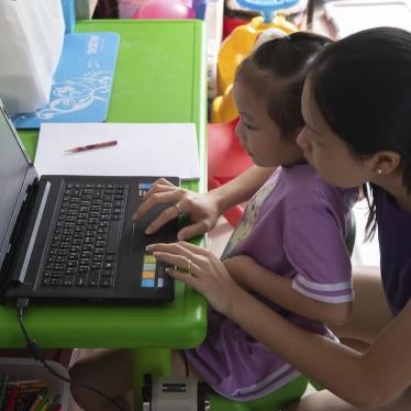 A schoolgirl taking online classes with her mother at home 
