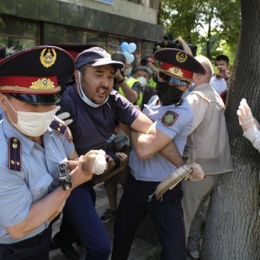 Police wearing a face masks to protect against coronavirus, detain a protester during an unsanctioned protest in Almaty, Kazakhstan, Saturday, June 6, 2020.