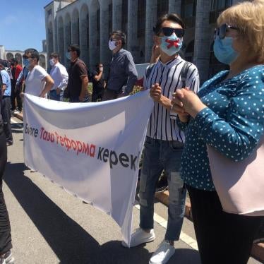 Protesters at a free speech rally in Bishkek on June 29 hold up a sign that reads “We need clean reforms!”