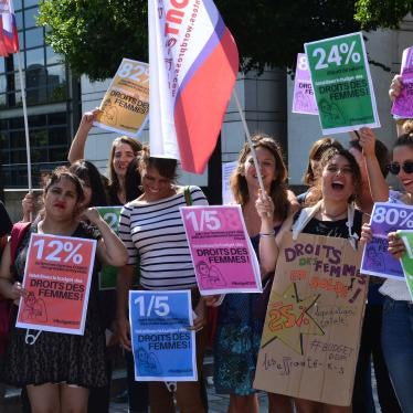 People holding signs against sexual harassment at work protest cuts to France's Ministry of Women's Rights budget, July 21, 2017.