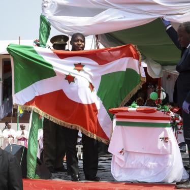 Burundi’s President Evariste Ndayishimiye holds the national flag after his inauguration in Gitega, Burundi, on June 18, 2020. 