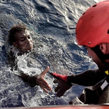 A man is rescued from the Mediterranean Sea by a member of Proactiva Open Arms NGO some 20 nautical miles north of Libya on October 3, 2016.  © 2016 Getty Images