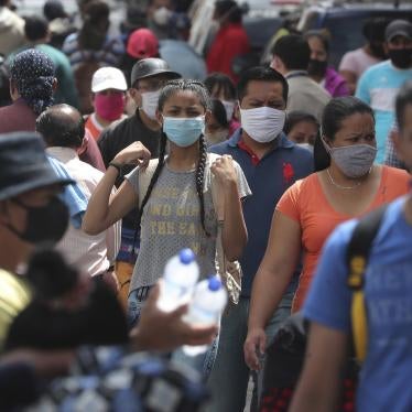 People wearing masks walk downtown amid the new coronavirus pandemic in Quito, Ecuador on Monday, June 29, 2020.