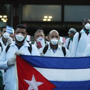 Medics and paramedics from Cuba pose upon arrival at the Malpensa airport of Milan, Italy, Sunday, March 22, 2020. Fifty-three doctors and paramedics from Cuba arrived in Milan to help with coronavirus treatment.