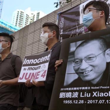 Activists hold placards and picture to mark anniversary of death of Chinese Nobel prize winner Liu Xiaobo outside a district court in Hong Kong, July 13, 2020.