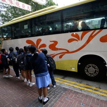 Children wait for a school bus in Hong Kong, November 20, 2019.