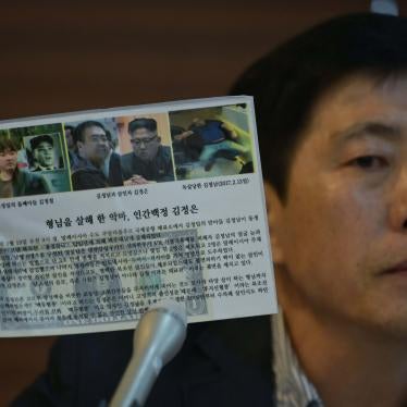 Activist Park Sang-hak holds a leaflet depicting the death of Kim Jong Nam, half-brother to North Korean leader Kim Jong Un, during a press conference in Seoul on July 6, 2020. © 2020 Photo by ED JONES/AFP via Getty Images
