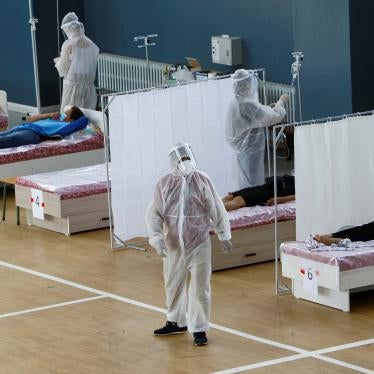 Medical specialists wearing personal protective equipment (PPE) treat patients at a day hospital, which is located in a school gym and provides services free of charge, in Bishkek, Kyrgyzstan July 16, 2020.