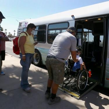 Patrons get on an express bus set up by the city Phoenix, Arizona, to take people to a heat relief station inside the Phoenix Convention Center, May 29, 2020.