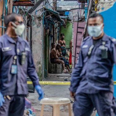 Security personnel patrol a migrant worker accommodation block under quarantine for Covid-19, Malé, Maldives, May 9, 2020.