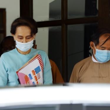 Myanmar leader Aung San Suu Kyi, left, and President Win Myint, wearing face masks to protect against the new coronavirus, leave after a Central Executive Committee meeting at their National League for Democracy (NLD) party headquarters in Naypyitaw, Myanmar Tuesday, July 21, 2020. 