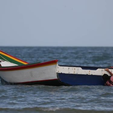 A girl holds a boat while playing at La Salina area, from where Maroly Bastardo, an eight months pregnant woman, along with her children, her husband's sister, uncle and father, boarded a smuggler's boat and disappeared in the Caribbean Sea during an attempt to cross from Venezuela to Trinidad and Tobago, in Guiria, Venezuela, May 24, 2019. 