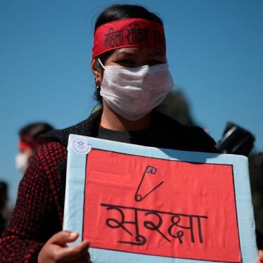 A woman holds a placard during a demonstration on International Women's Day to protest against inequality and sexual violence, March 8, 2020.