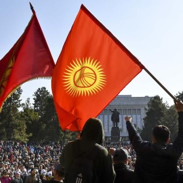 Protesters react waving Kyrgyz national flags as they wait for Kyrgyz Prime Minister Sadyr Zhaparov speech in front of the government building in Bishkek, Kyrgyzstan, Wednesday, Oct. 14, 2020.