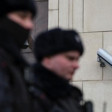 Police officers walk past a surveillance camera in central Moscow, Russia January 26, 2020.