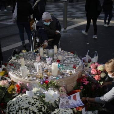 People set flowers at a memorial in front of the Notre Dame church, in Nice, France, October 30, 2020.